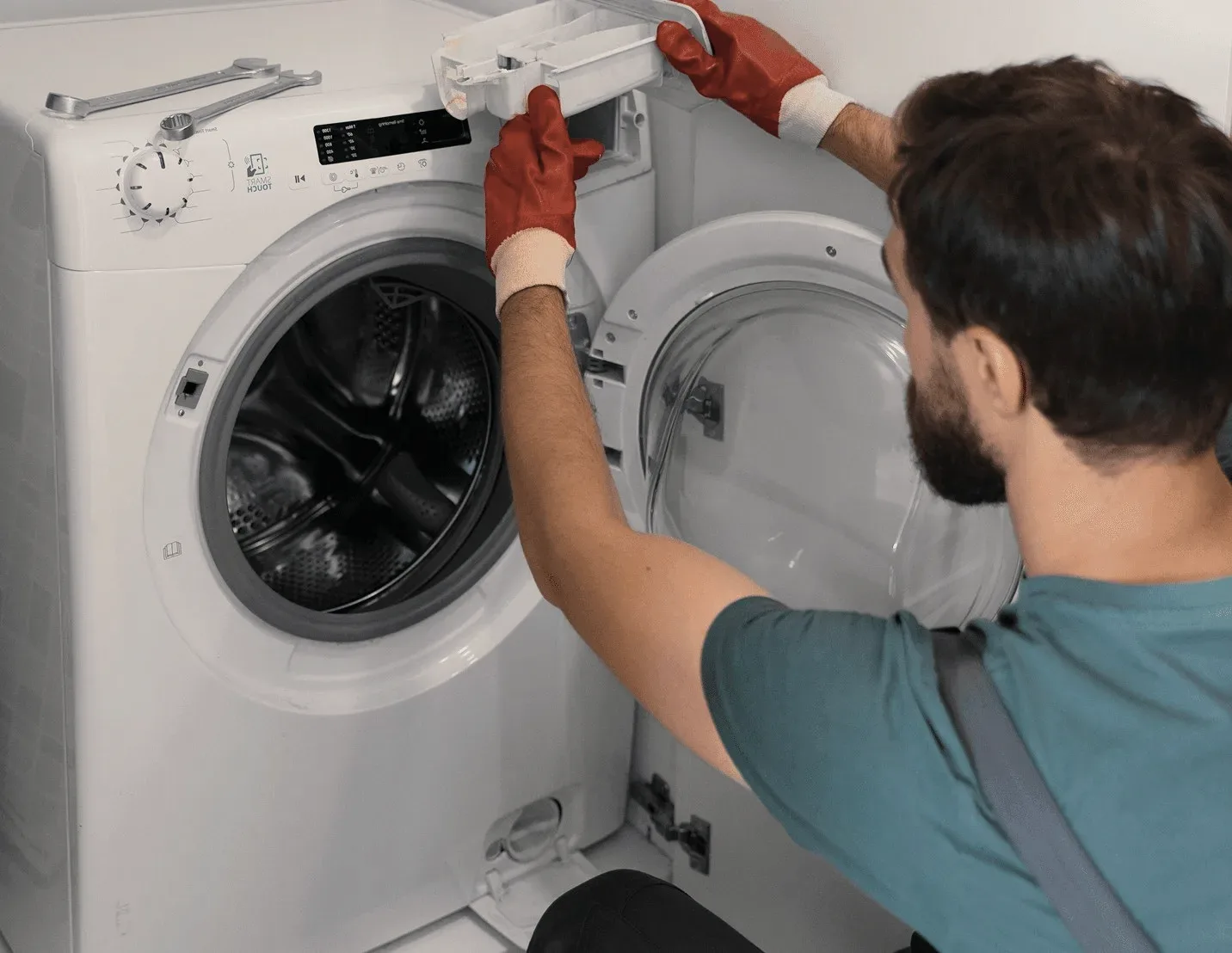 A technician working on a washing machine.
