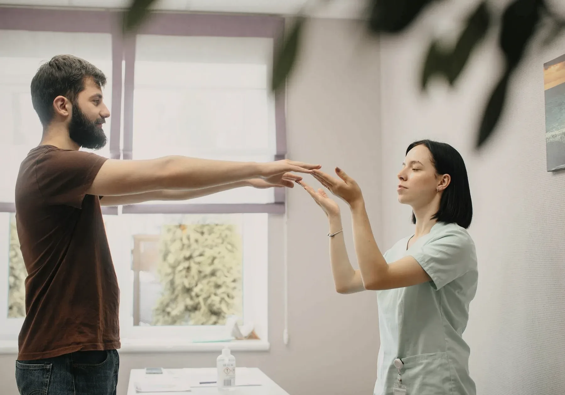 A physiotherapist guiding a patient's arms.