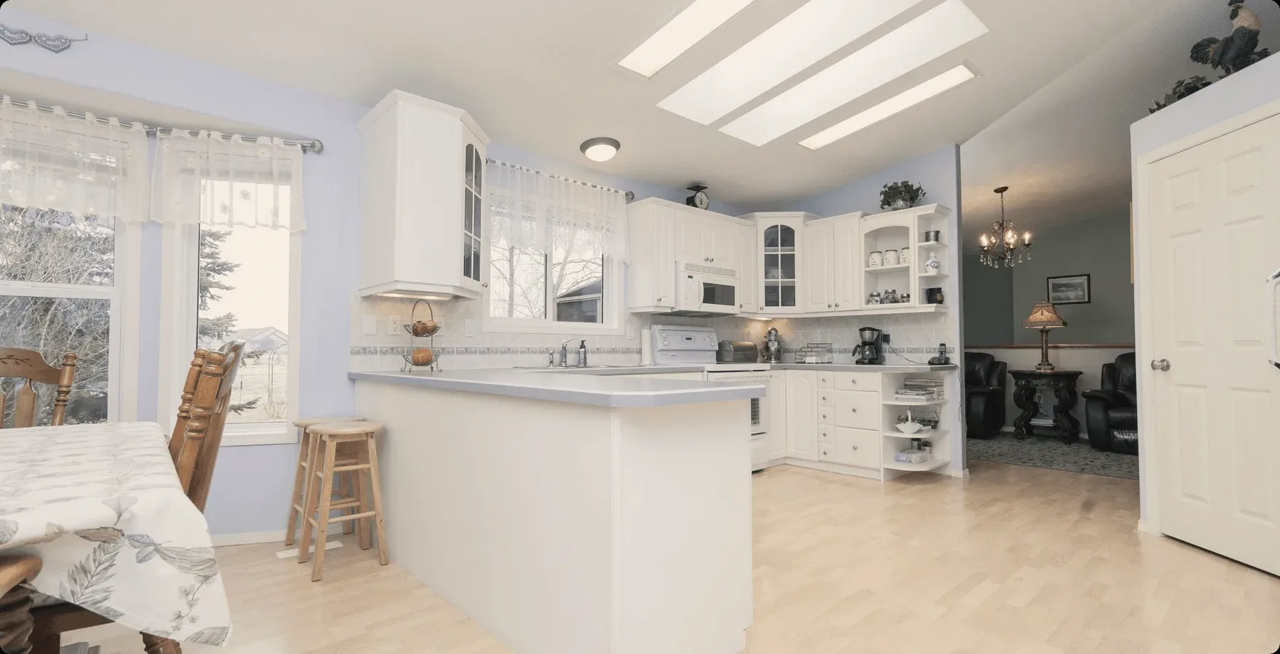 A white kitchen with skylights.