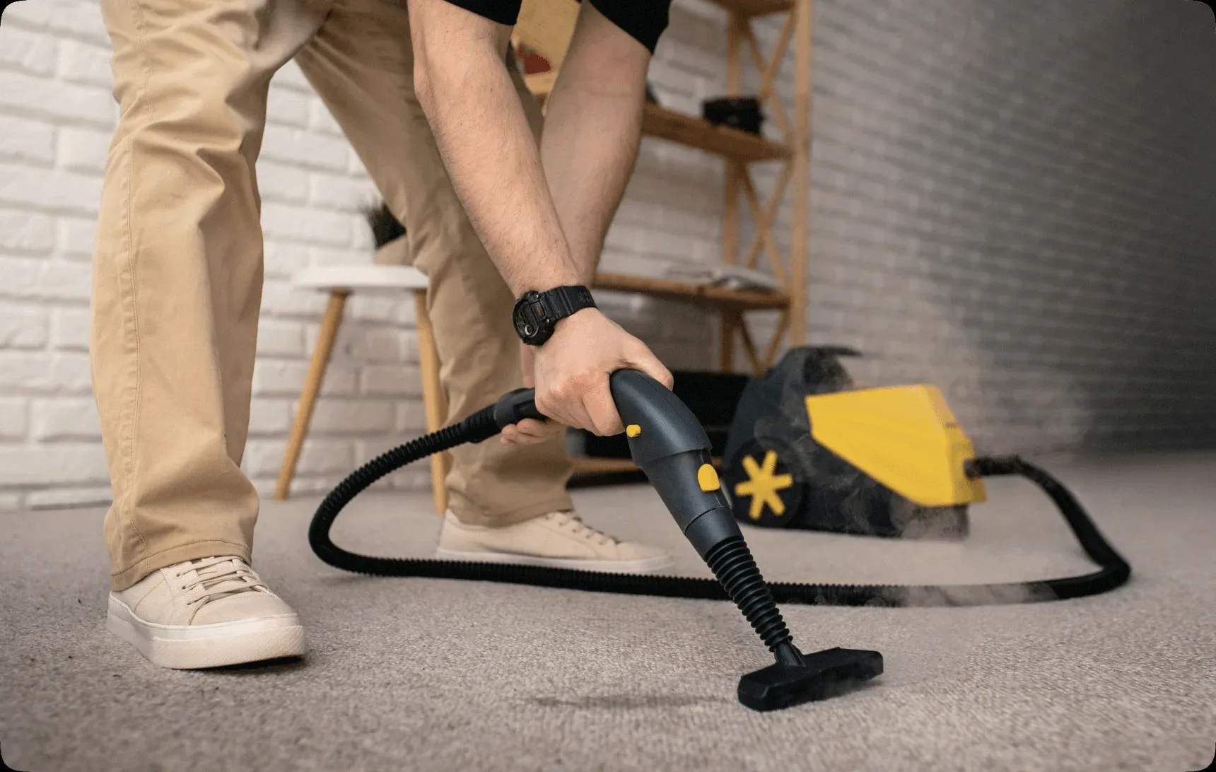 A steam cleaner on a beige carpet.