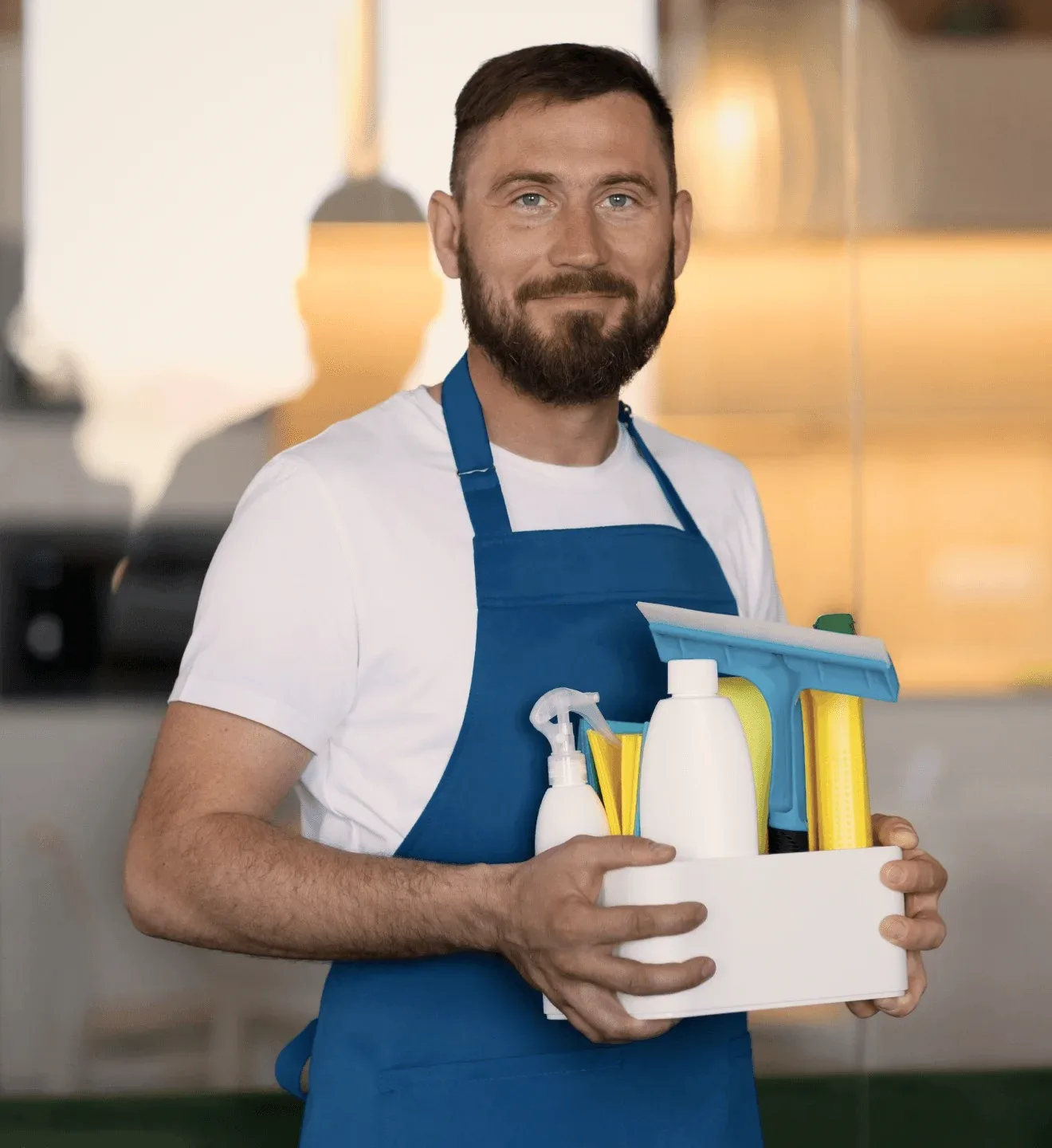 A cleaner in a blue apron holding a caddy of bottles.