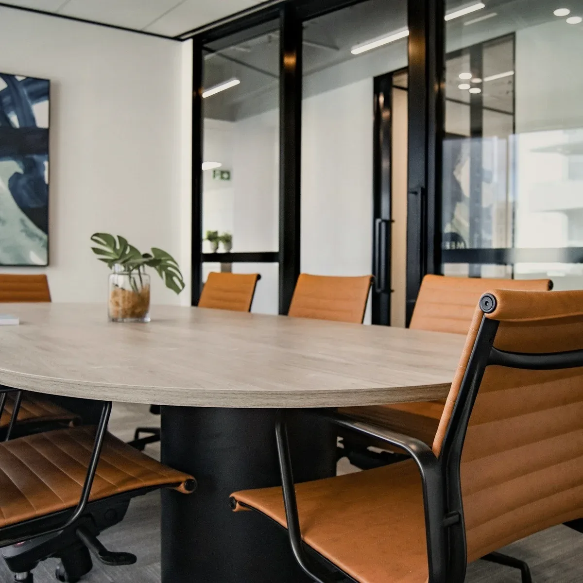 An empty meeting room with leather chairs.