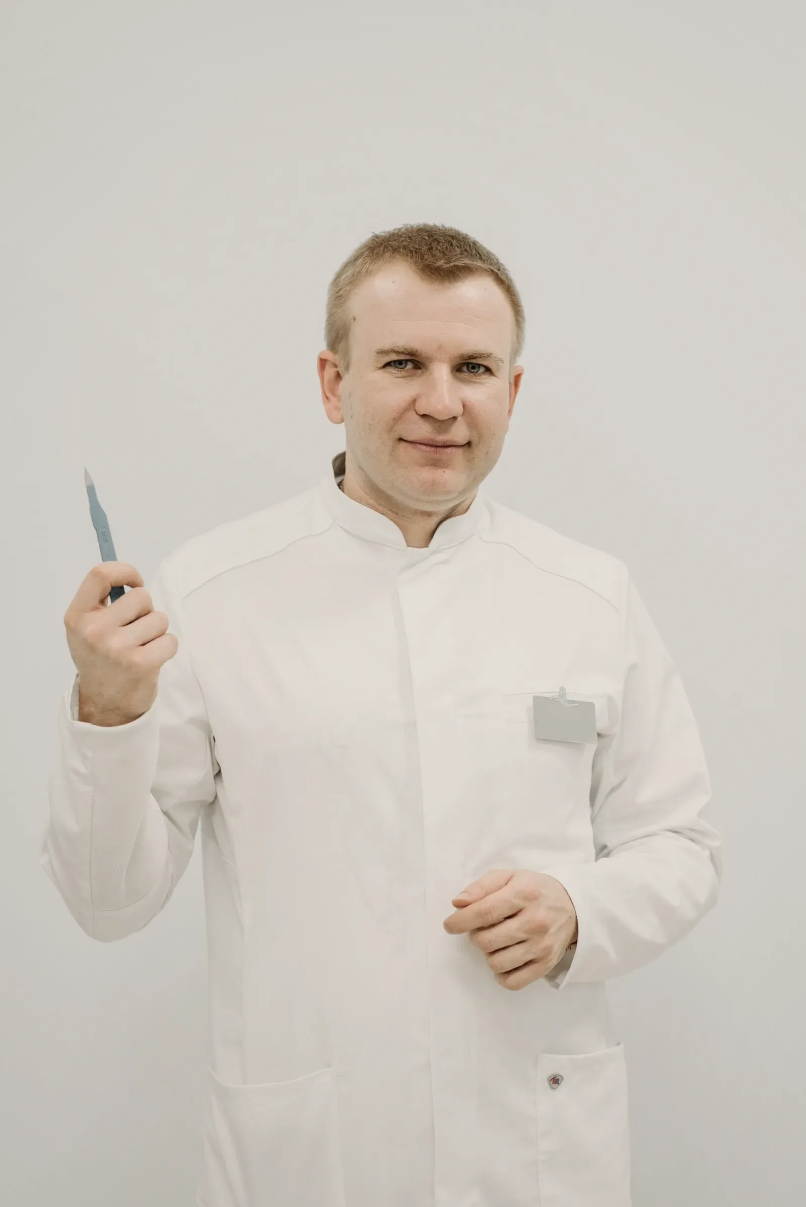 A dermatologist photographed against a plain background.