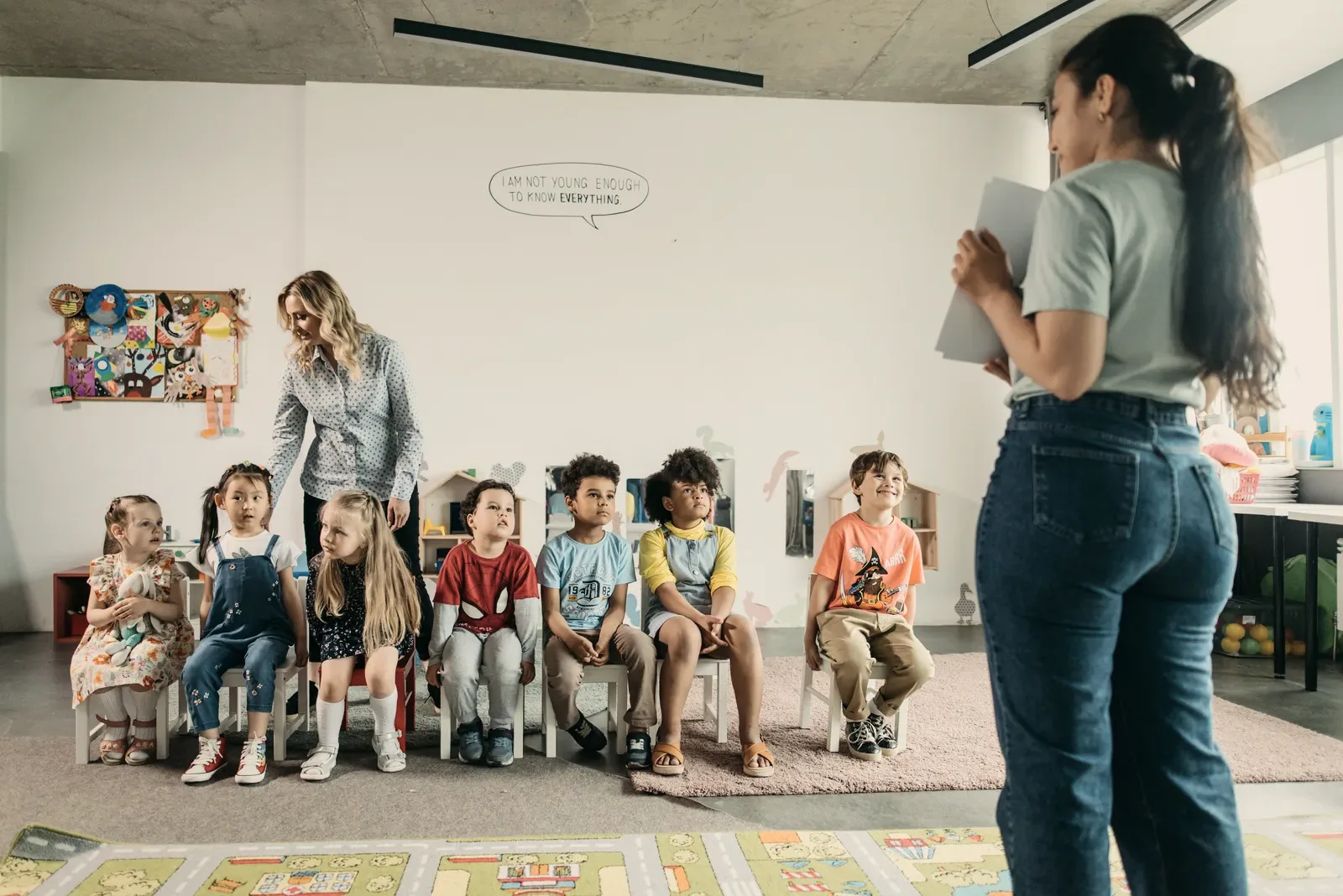 A teacher working with a small group of students around one table.