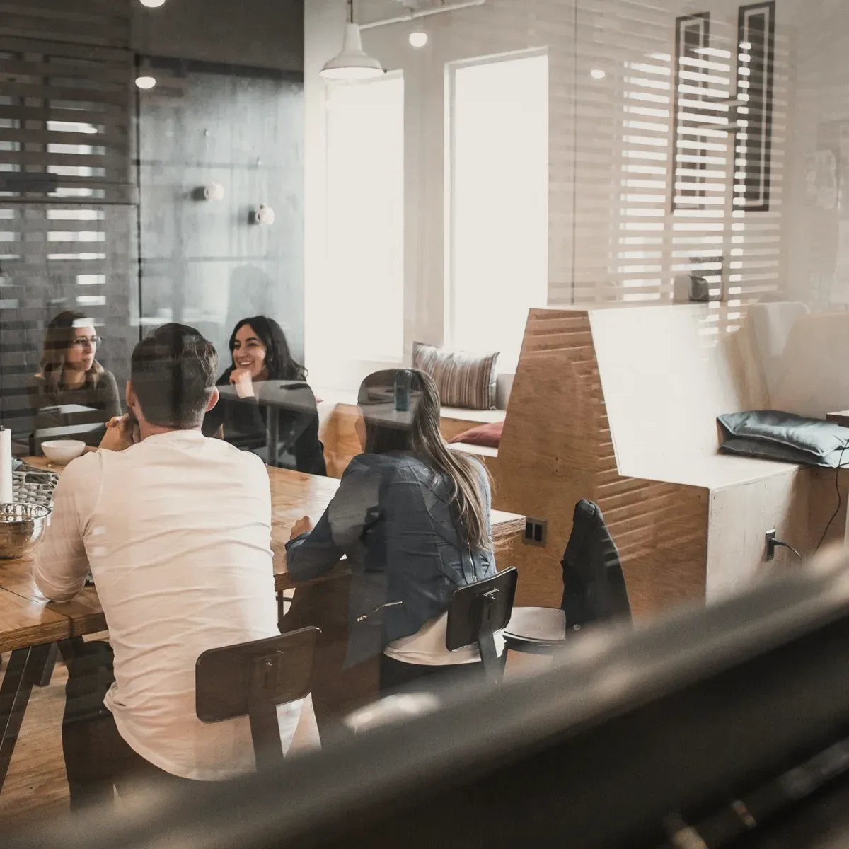 People seated in a bright office.