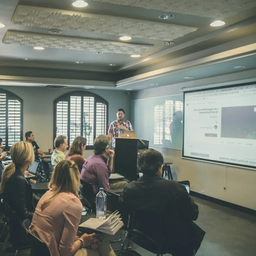 A lecture in a wood-panelled hall.