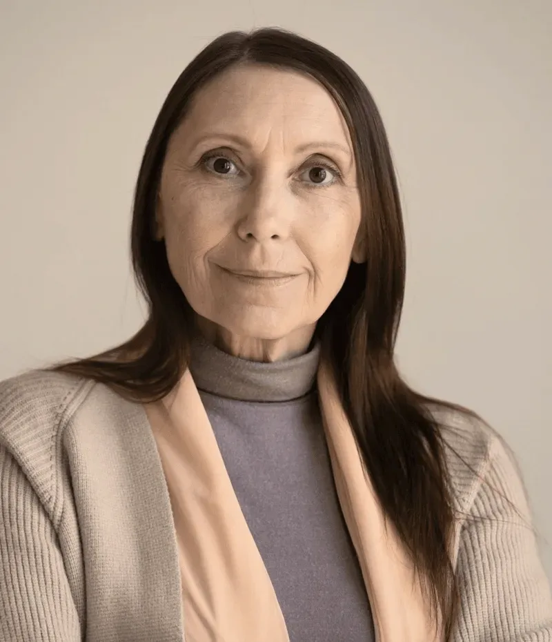 A woman in a beige jacket.