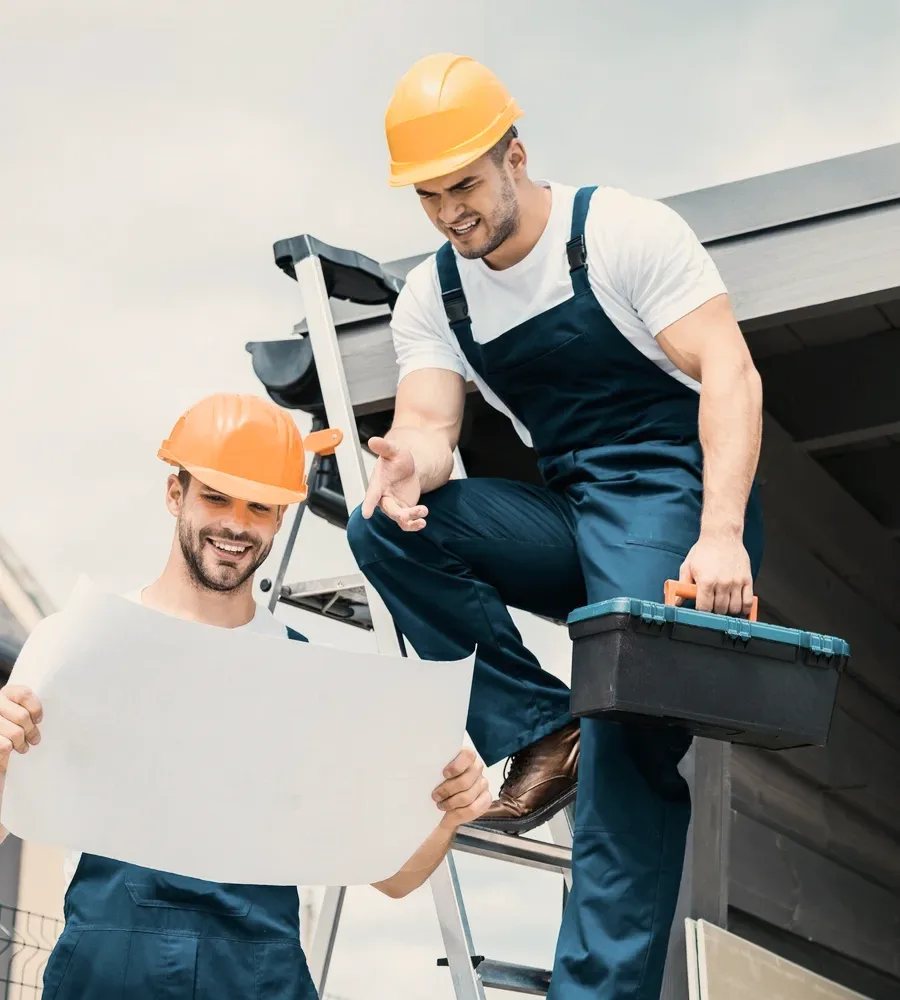 A roofer with a toolbox on a ladder.
