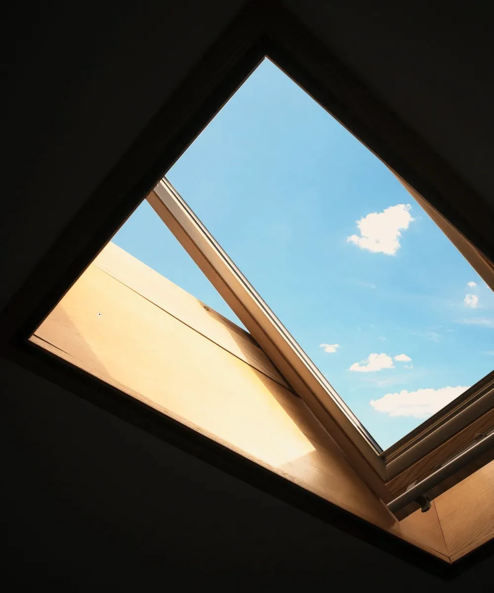 A skylight open to a blue sky.