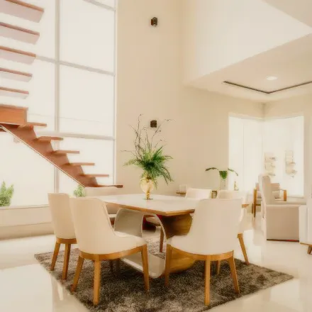 An open dining area with a wooden table and white chairs.