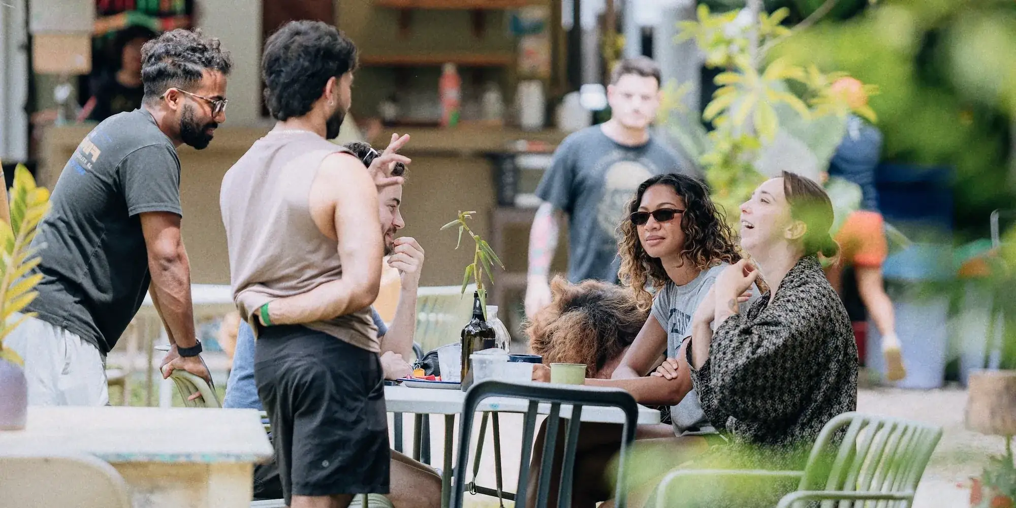 Guests talking and laughing at the garden bar.
