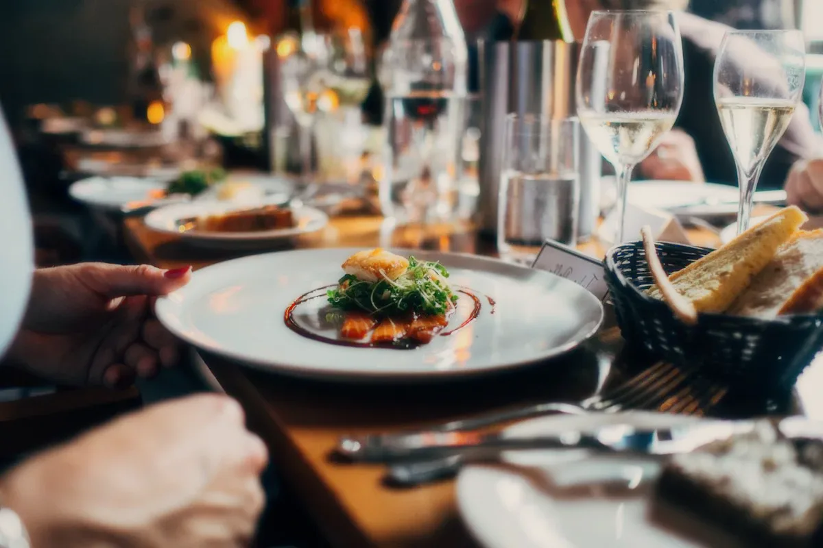A plate being served at a set table.