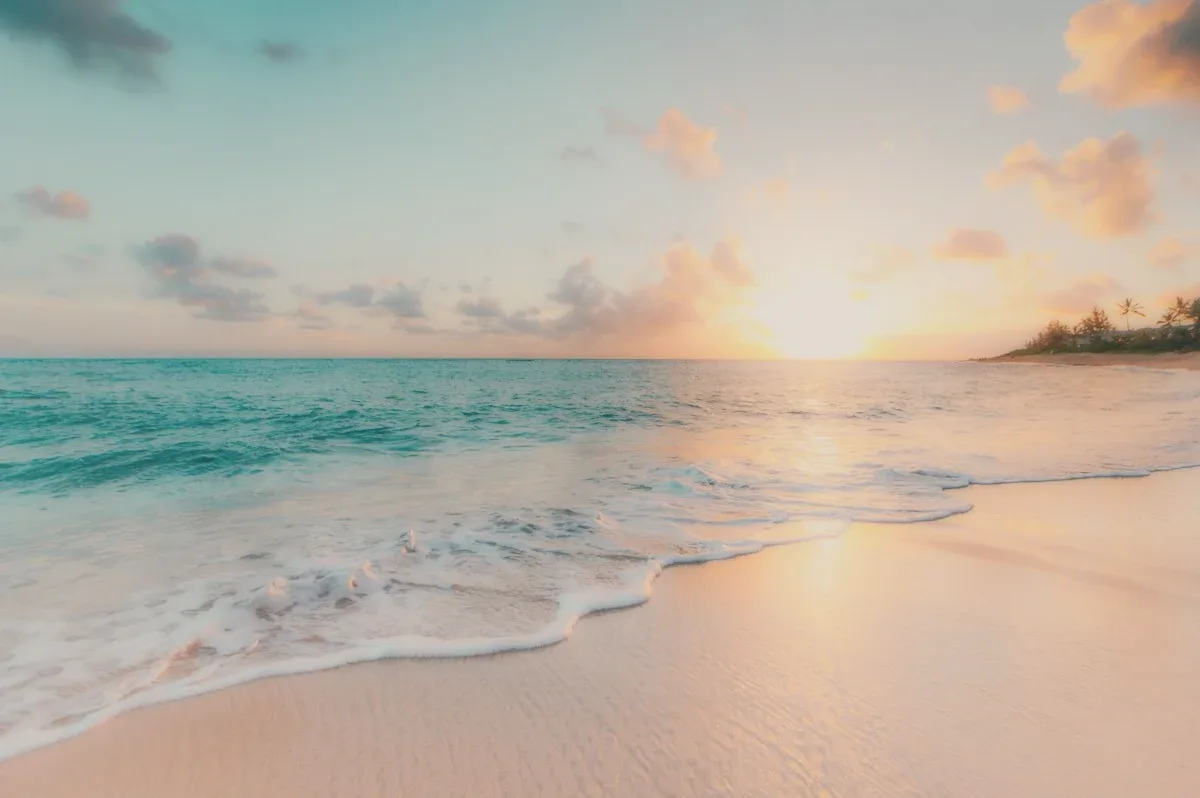 A beach at sunset, the tide going out.