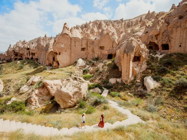 Rock houses cut into a valley in Cappadocia.