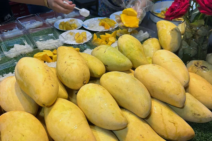 Ripe yellow mangoes at a street stall.