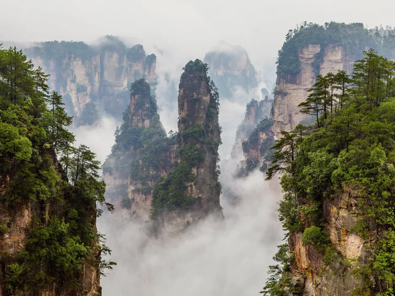 Stone pillars of Zhangjiajie rising out of the mist.