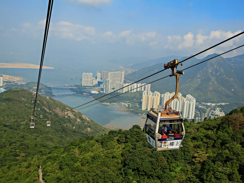 A cable car above the green hills on the way to Ngong Ping.