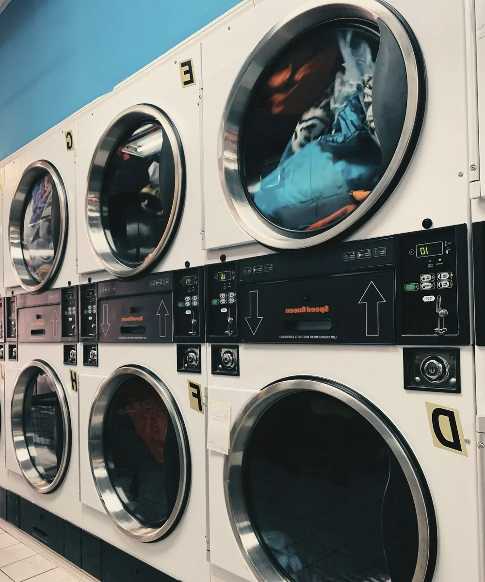 Stacked washing machines in a laundrette.