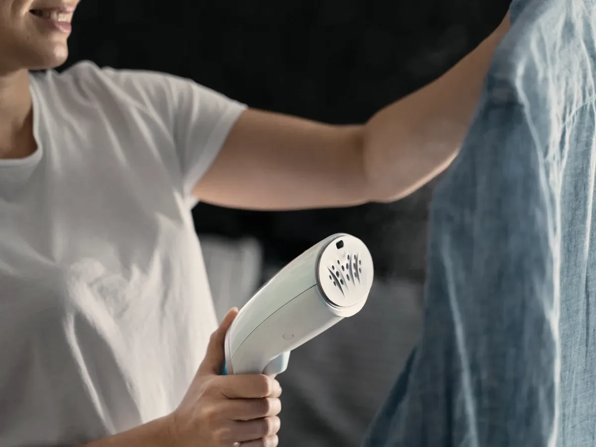 A garment steamer on a shirt.
