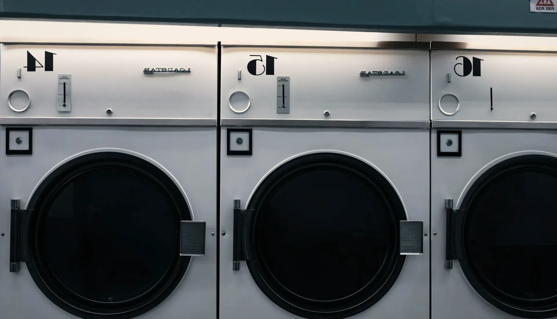 Numbered washing machines in a laundrette.