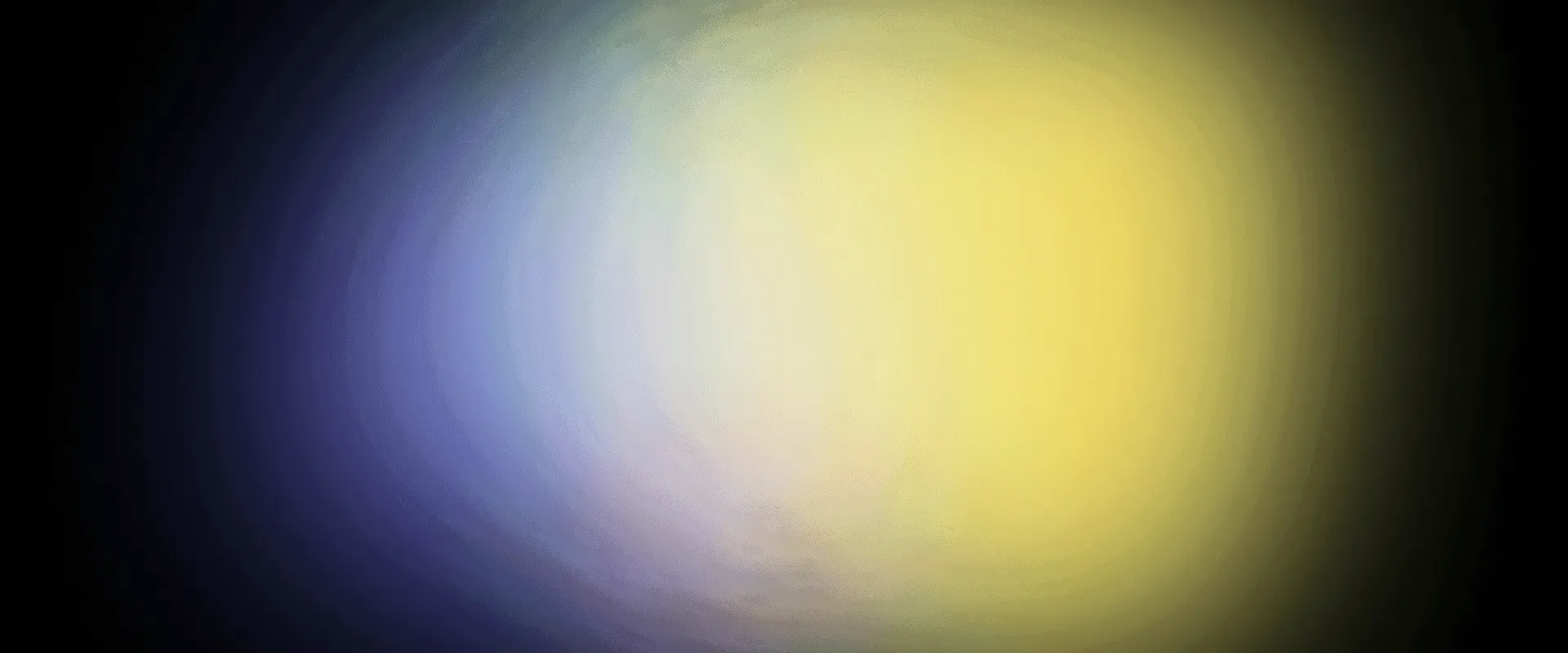 A soft yellow and blue glow on black.