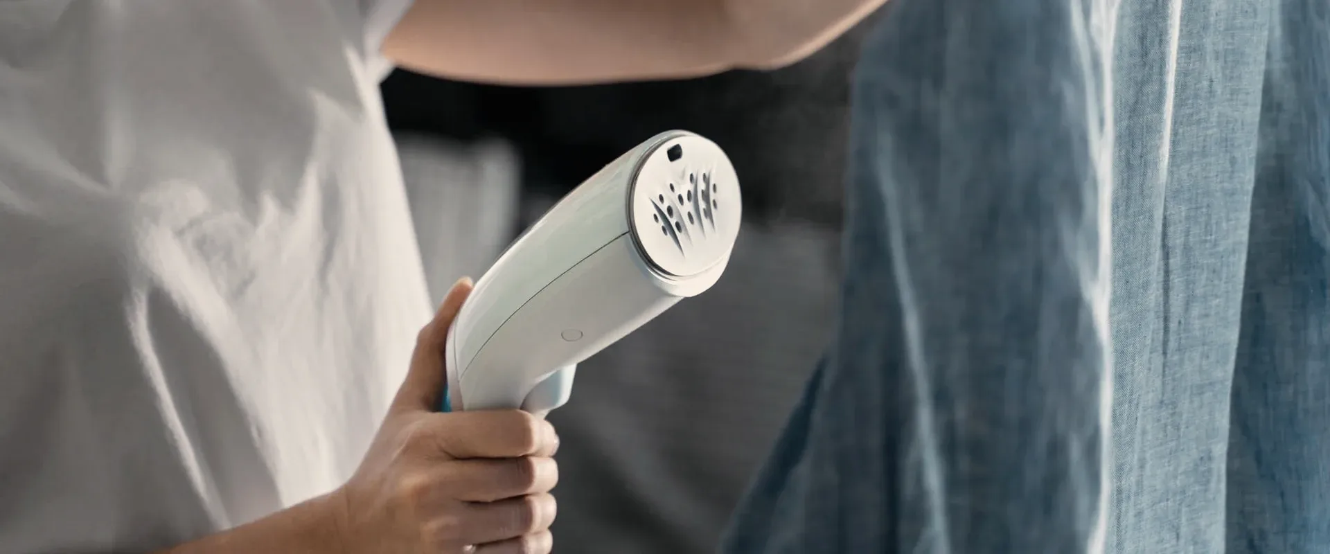 A garment steamer on a shirt.