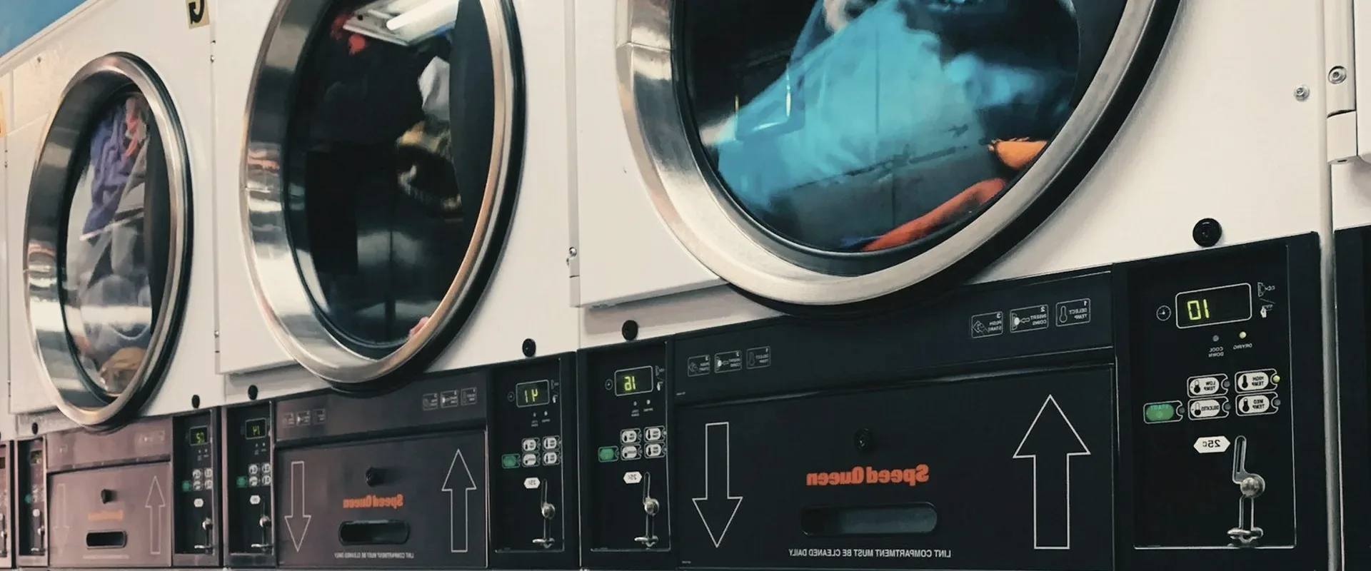 Washing machines in a laundrette.