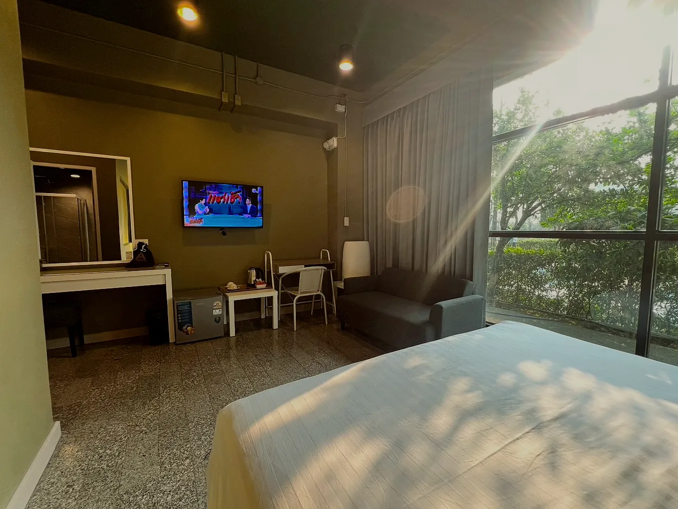The deluxe room in the morning sun, the desk by the window.