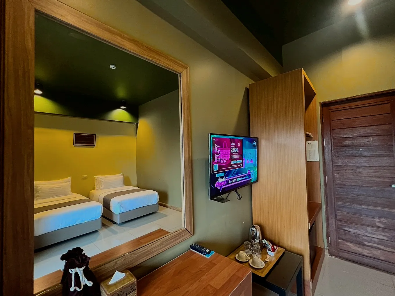 The twin room seen in the mirror over the desk.