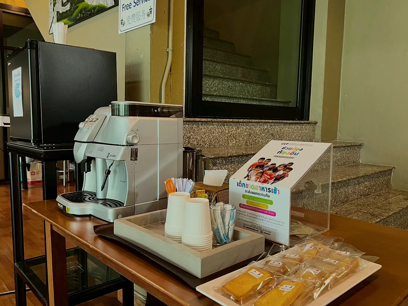 The coffee corner at the front desk: a coffee machine, cups and snacks.