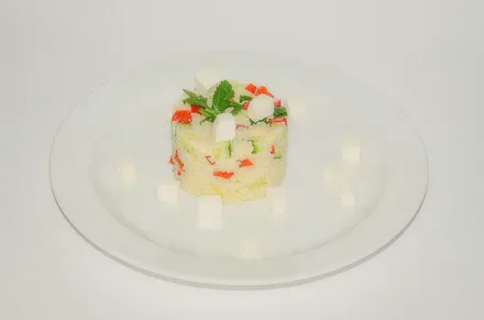 A small tower of diced vegetables on a white plate.
